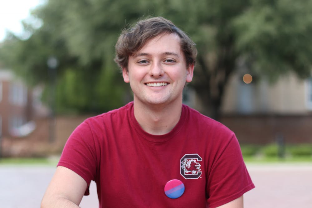 Caleb Bozard, The Daily Gamecock's assistant news editor, poses for a photo on the steps in front of the Thomas Cooper Library fountain. Bozard identifies as a bi-sexual cis-gendered man and uses he/him pronouns.