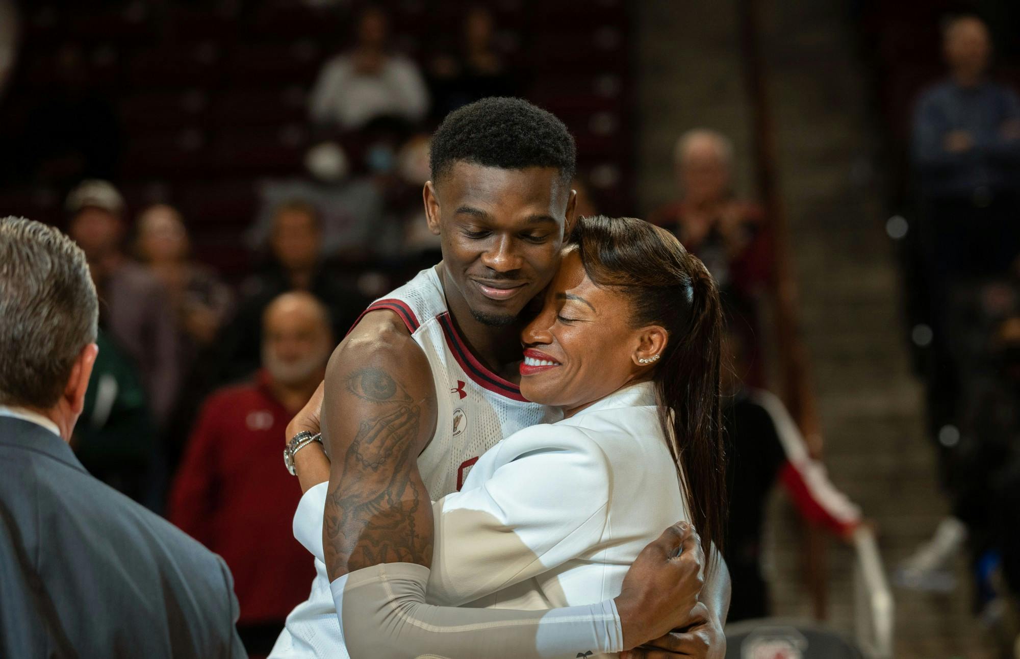 Keyshawn Bryant hugs loved one during senior night during the ceremony following the game on Tuesday, March 1, 2022.
