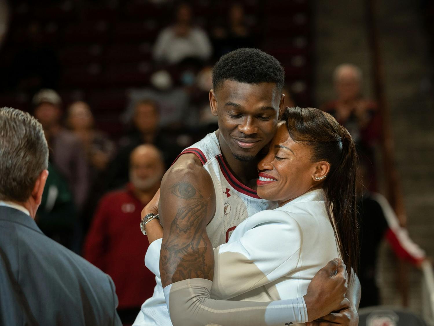 Keyshawn Bryant hugs loved one during senior night during the ceremony following the game on Tuesday, March 1, 2022.