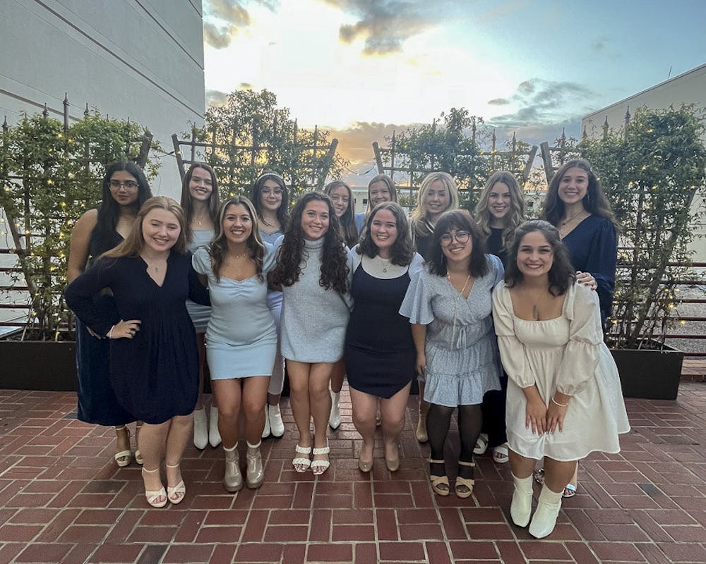 <p>Members of The Cocktails pose outside of the Koger Center for the Arts after their winter recital on Dec. 2, 2022. The all-female a capella group is organized and ran by students who perform live events around Columbia and release their content online.</p>