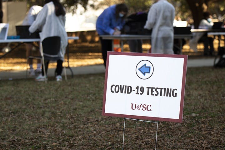 A sign marks the check-in area for COVID-19 testing on Davis Field.&nbsp;