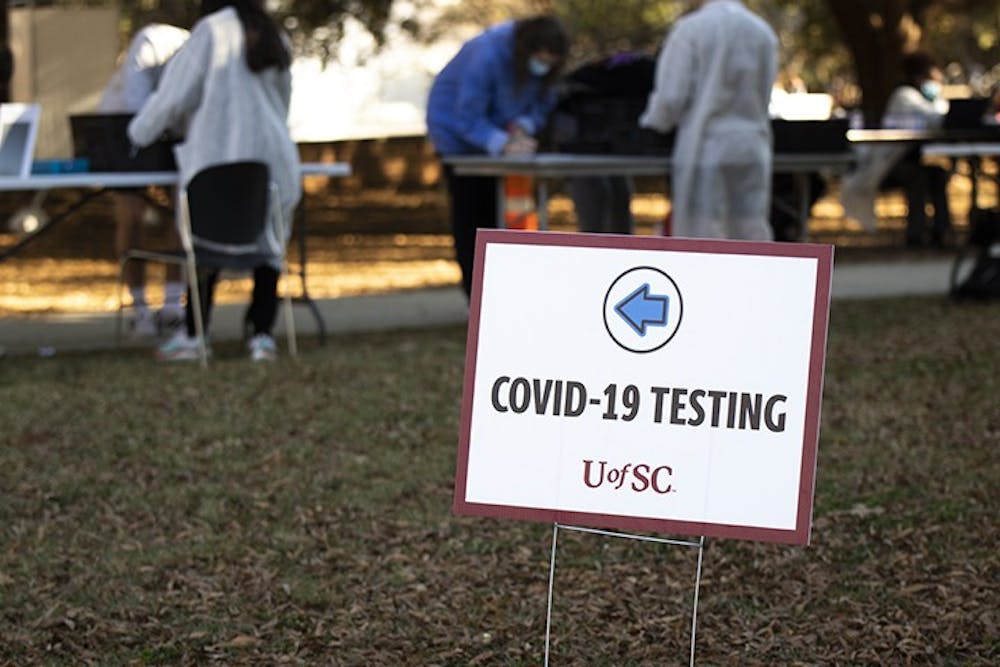 <p>A sign marks the check-in area for COVID-19 testing on Davis Field.&nbsp;</p>