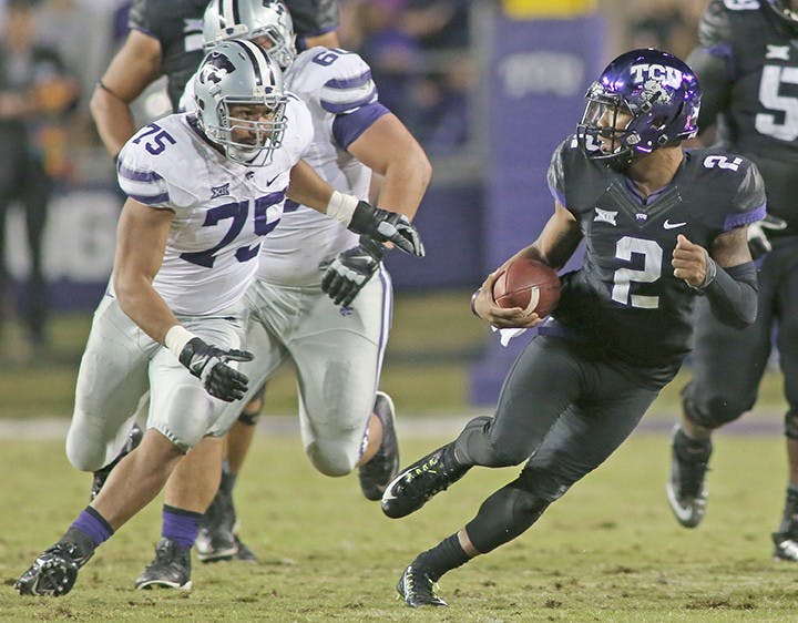 Texas Christian quarterback Trevone Boykin (2) scrambles away from Kansas State&apos;s Jordan Willis (75) for a first down the first quarter against Kansas State at Amon Carter Stadium in Fort Worth, Texas, on Saturday, Nov. 8, 2014. (Paul Moseley/Fort Worth Star-Telegram/MCT)