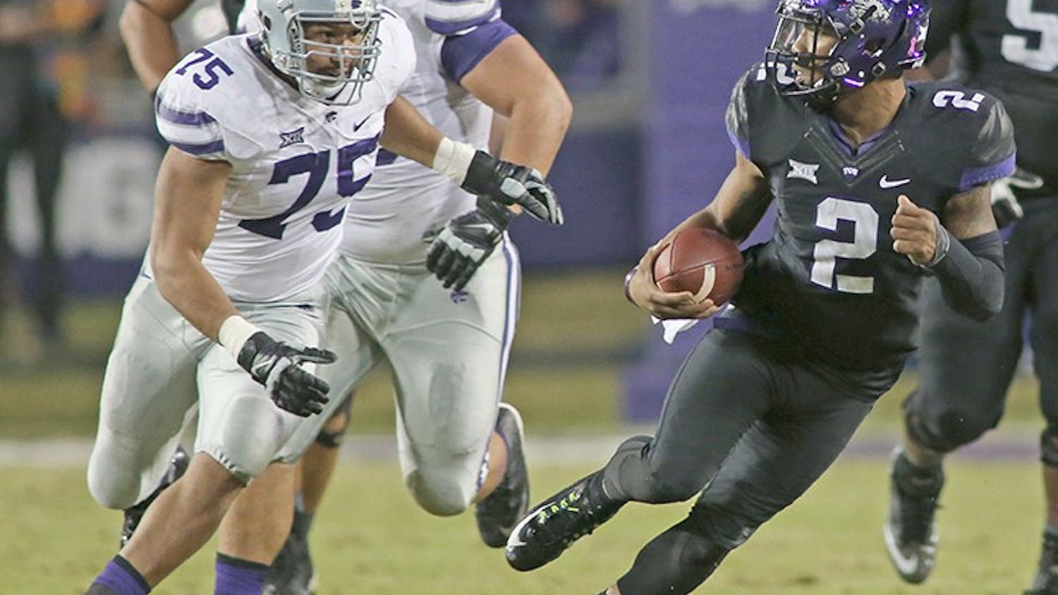 Texas Christian quarterback Trevone Boykin (2) scrambles away from Kansas State&apos;s Jordan Willis (75) for a first down the first quarter against Kansas State at Amon Carter Stadium in Fort Worth, Texas, on Saturday, Nov. 8, 2014. (Paul Moseley/Fort Worth Star-Telegram/MCT)