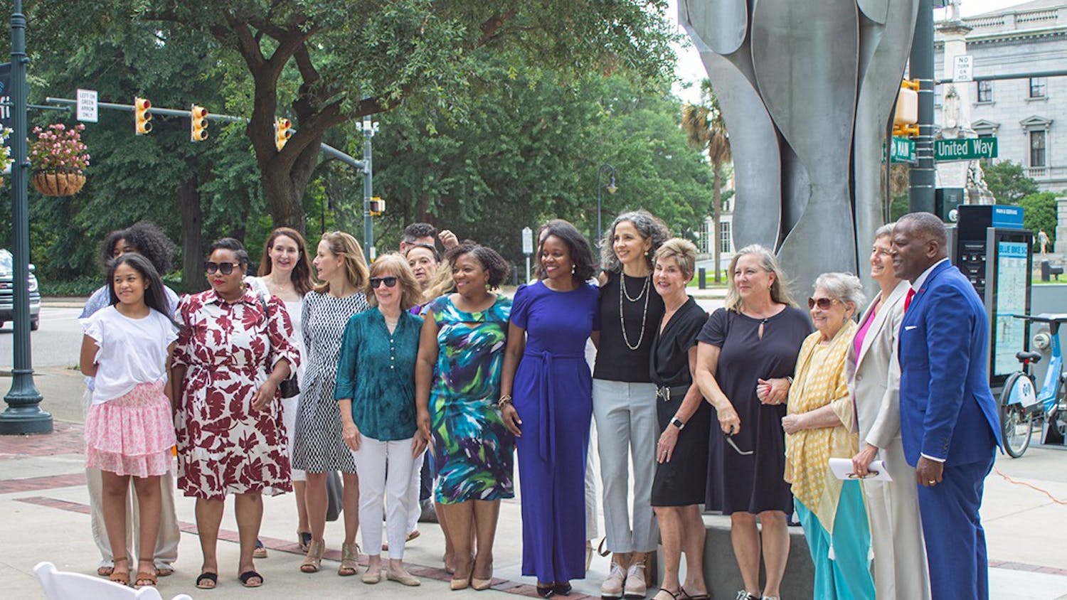 Attendees of the unveiling of the Architecture of Strength earlier this year take a photo in front of the monument. The monument is on the corner of Main and Gervais Streets and was put up by the Columbia City of Women&nbsp;at a meaningful spot in the city to represent the power of women.