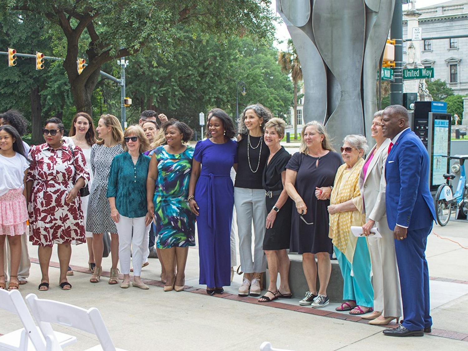 Attendees of the unveiling of the Architecture of Strength earlier this year take a photo in front of the monument. The monument is on the corner of Main and Gervais Streets and was put up by the Columbia City of Women at a meaningful spot in the city to represent the power of women.