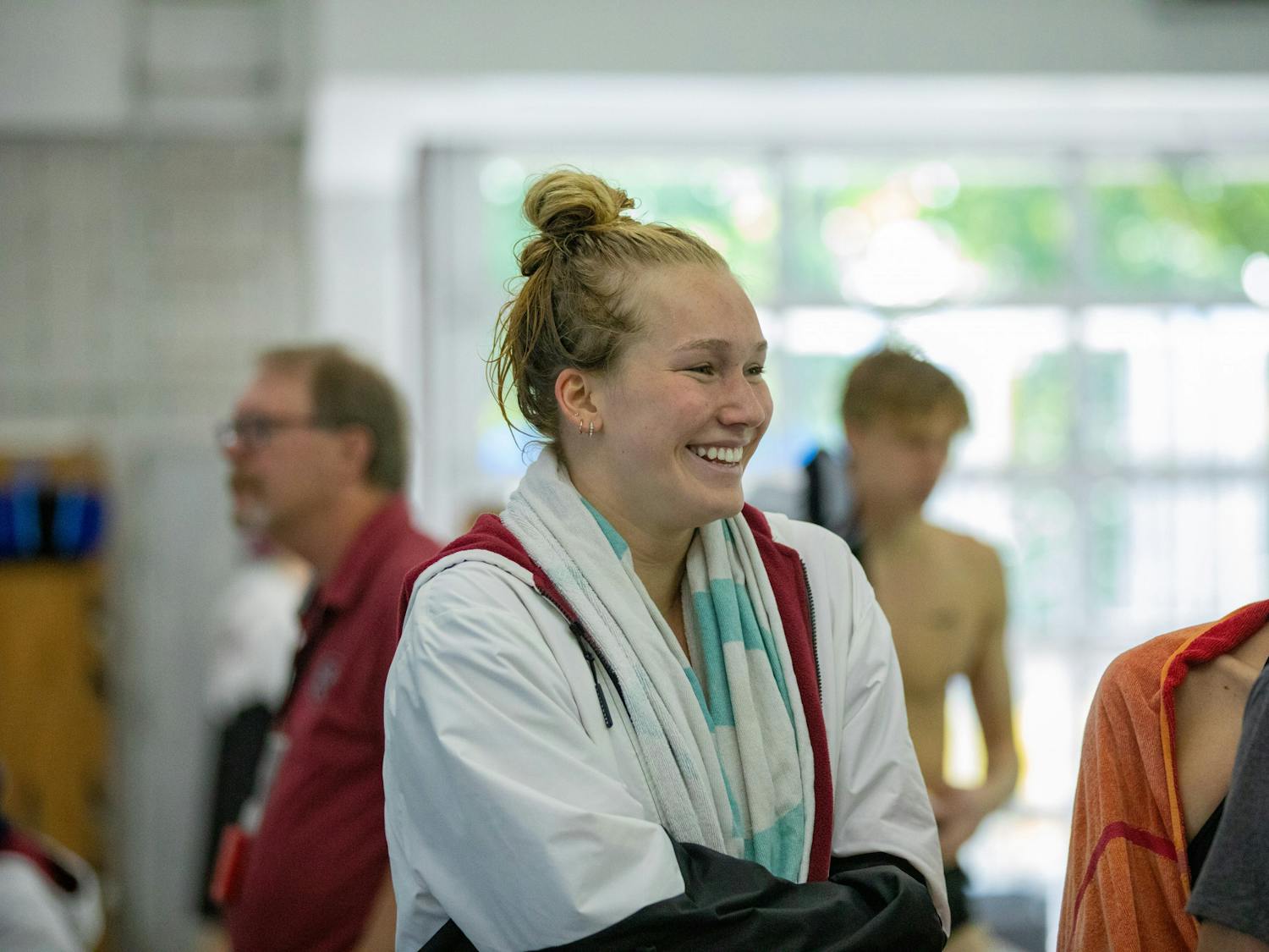 Junior Hayley Mason smiles with her teammates mid match during a swim meet against the LSU Tigers on Oct. 8, 2022. The women’s swim and dive team won 161.5-138.5 while the men’s swim and dive team lost 143-157 