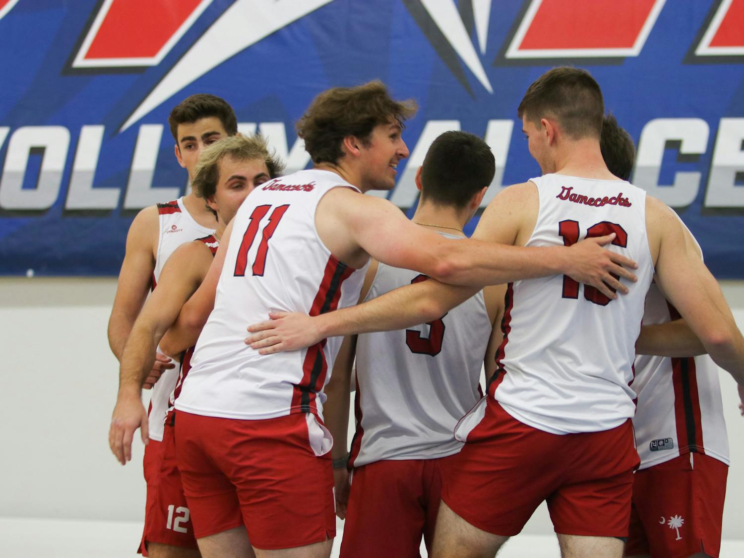 Junior opposite Nicholas Strivieri huddles and celebrates with the Black team after locking in another win in pool play against Georgia A. Although they split sets, Strivieri had a notable 8 point serving run that gave the Black team some much needed momentum.