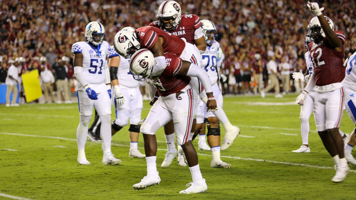 FILE — Redshirt senior defensive lineman Jabari Ellis and redshirt sophomore defensive back Cam Smith celebrate a big play against Kentucky on Sep. 25, 2021. The Wildcats defeated the Gamecocks 16-10.
