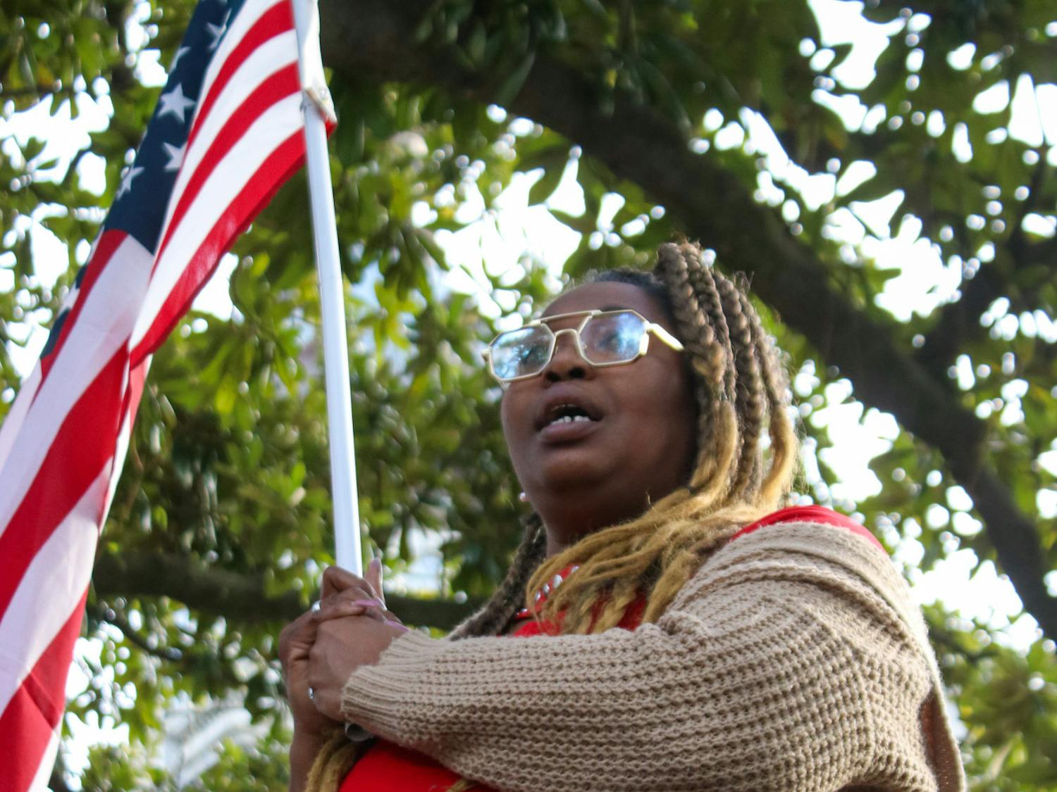 Virgina Mills holds an American flag while standing outside of the Statehouse on Jan. 28, 2023. Mills aligned herself with the Democratic party for about 30 years, before shifting ideologies. She said the Democratic Party weaponizes minority groups and overly generalizes them as struggling.&nbsp;