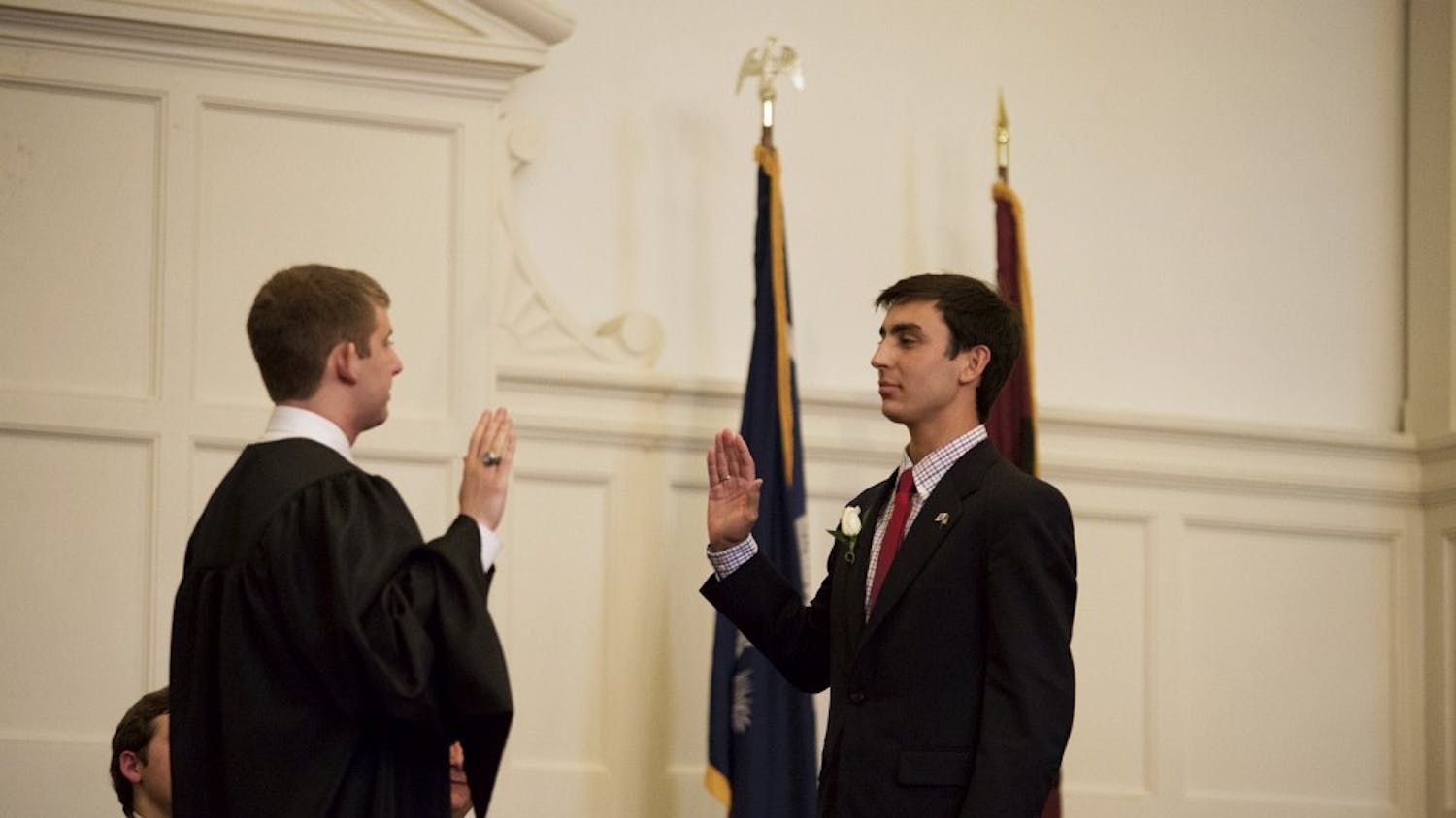 Kaufman, right, being inaugurated to the office of the presidency by Chief Justice Ross Abbott, left. The impeachment charges allege that Kaufman did not fill the post of Elections Commissioner within two weeks of his inauguration.