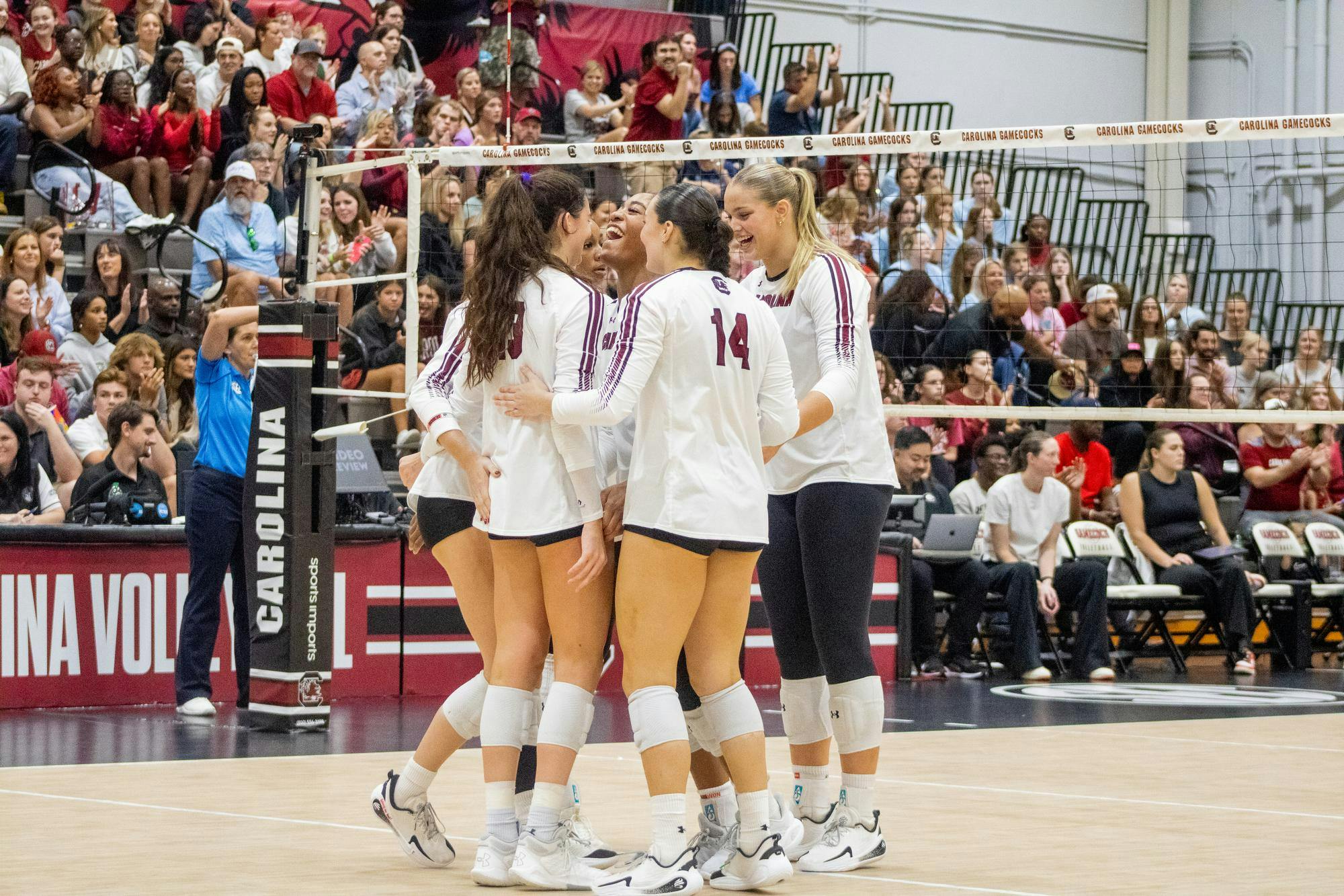 The South Carolina volleyball team huddled up with big smiles after winning a set against the University of Georgia on Oct. 5, 2025, at the Carolina Volleyball Center. USC took a loss to Georgia 3-1.
