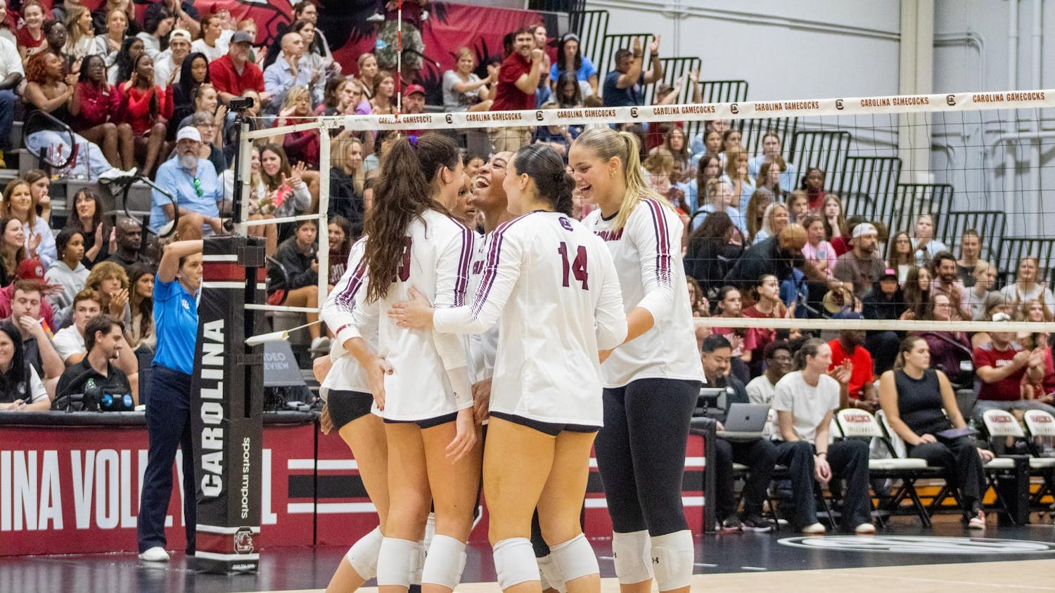 The South Carolina volleyball team huddled up with big smiles after winning a set against the University of Georgia on Oct. 5, 2025, at the Carolina Volleyball Center. USC took a loss to Georgia 3-1.