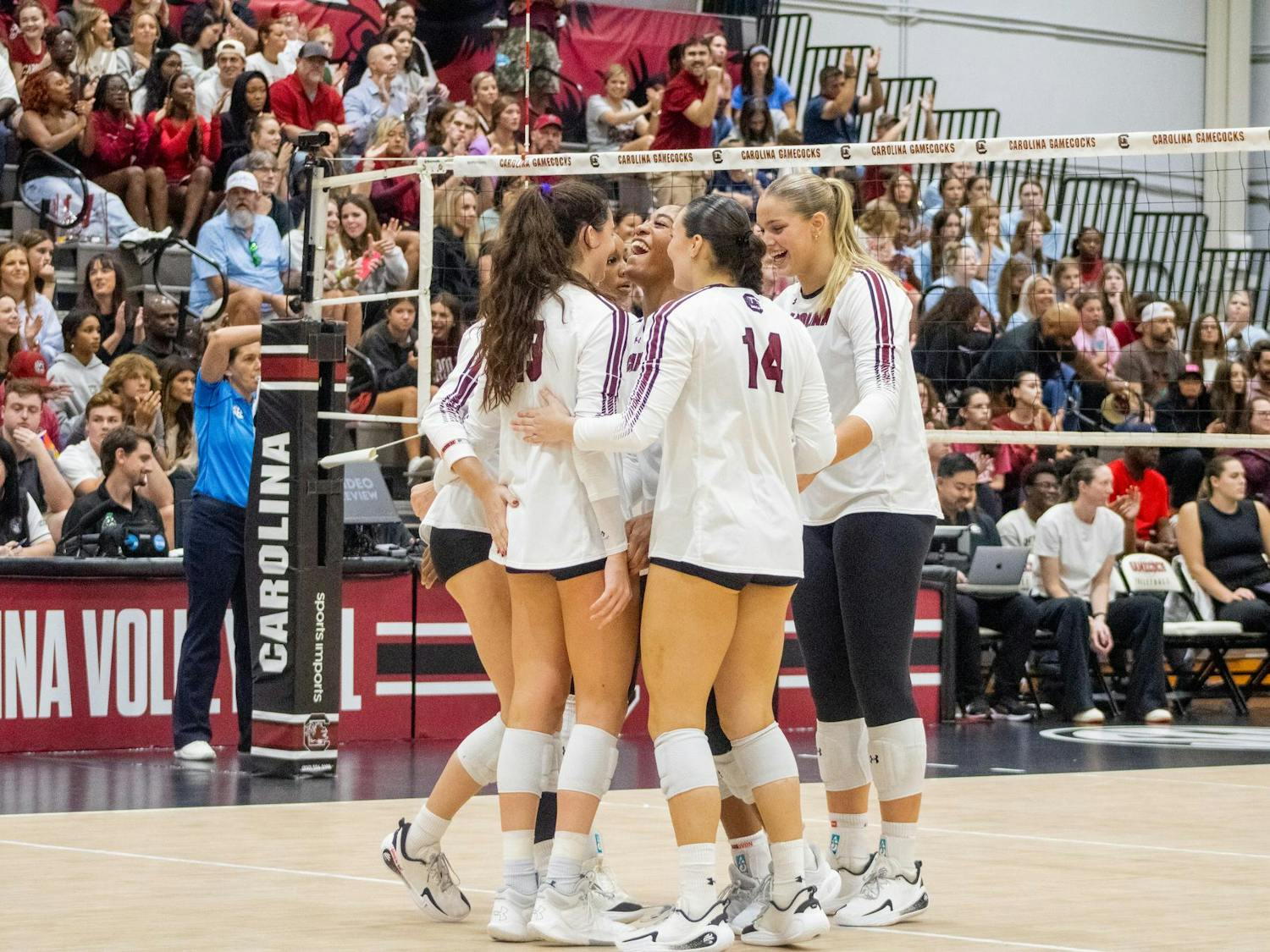The South Carolina volleyball team huddled up with big smiles after winning a set against the University of Georgia on Oct. 5, 2025, at the Carolina Volleyball Center. USC took a loss to Georgia 3-1.