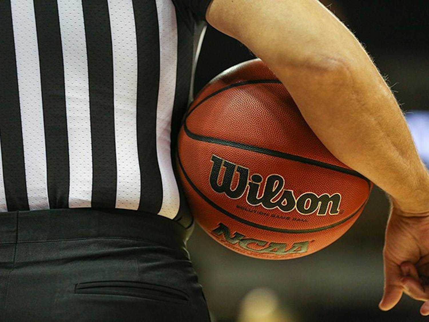 FILE— A referee holds a basketball under his arm during a timeout in a 2019 game at Colonial Life Arena in Columbia, SC.