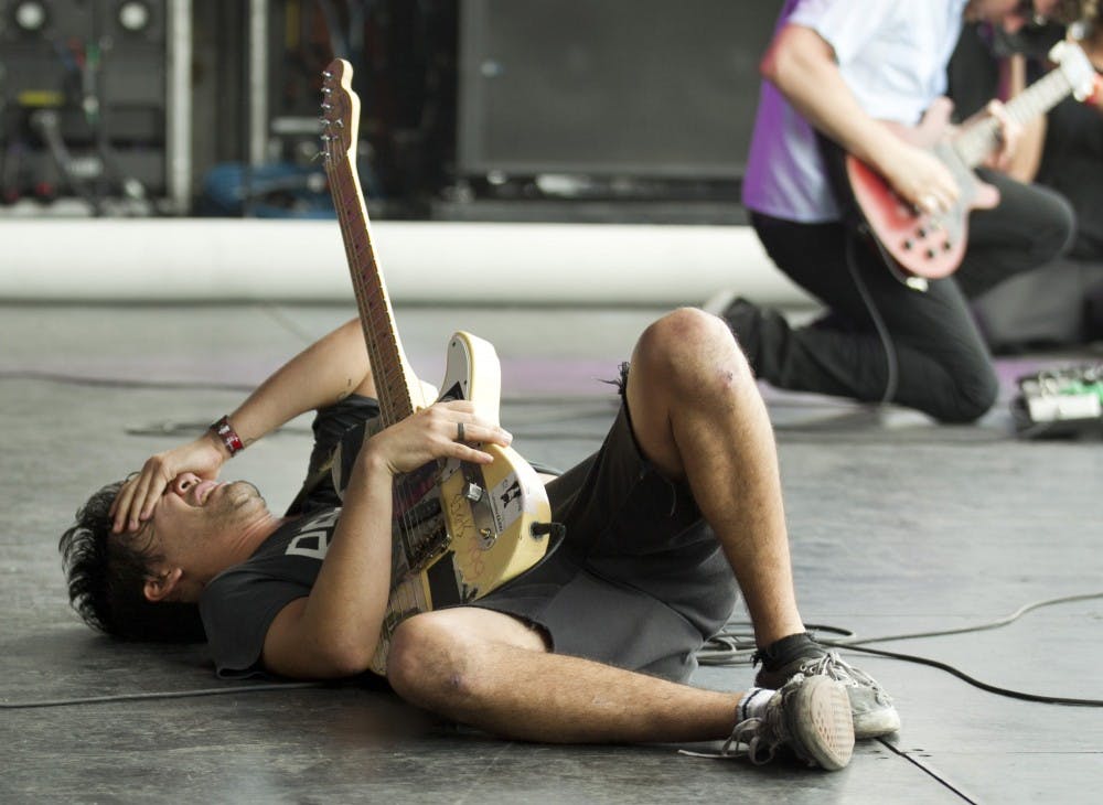 Zac Carper, of the Los Angeles skate punk band FIDLAR, falls to the stage near the end of his set at the Austin City Limits Music Festival in Austin, Texas in October 2013. (Jay Janner//Austin American-Statesman)