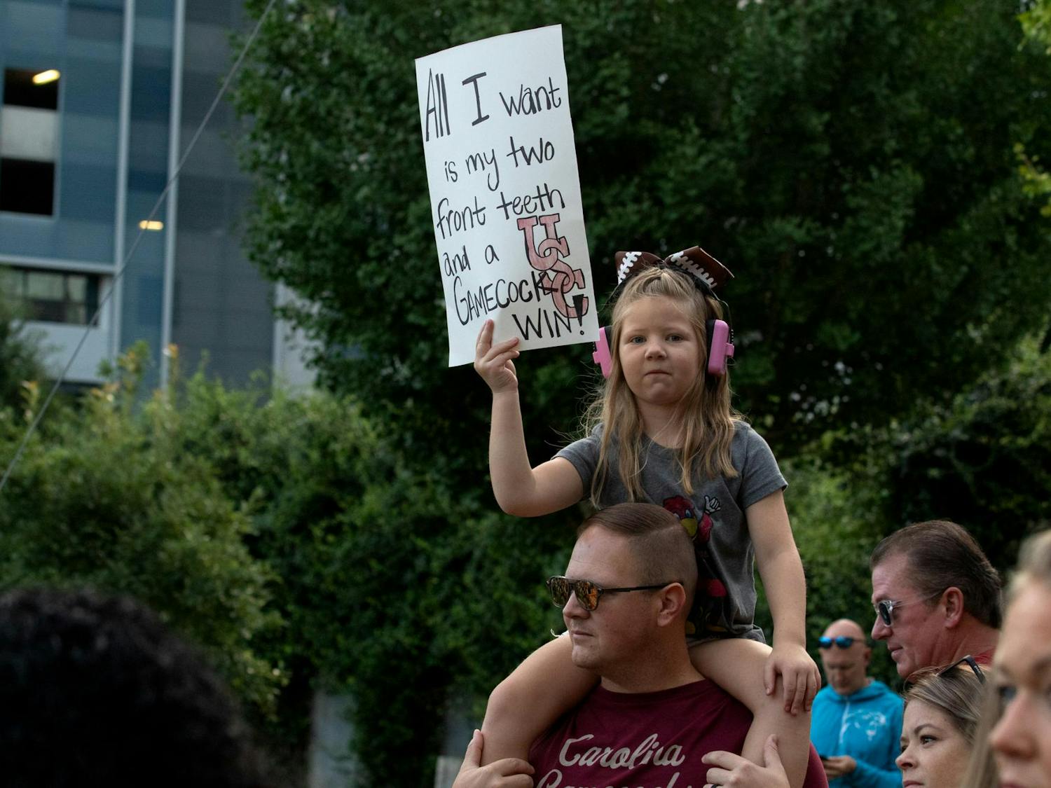 Young Gamecocks fan Riley Lawrence sits on her dad’s shoulders carrying a sign for College GameDay. Lawrence and her dad, Andrew, sported Cocky shirts for the show on Sept. 2, 2023.