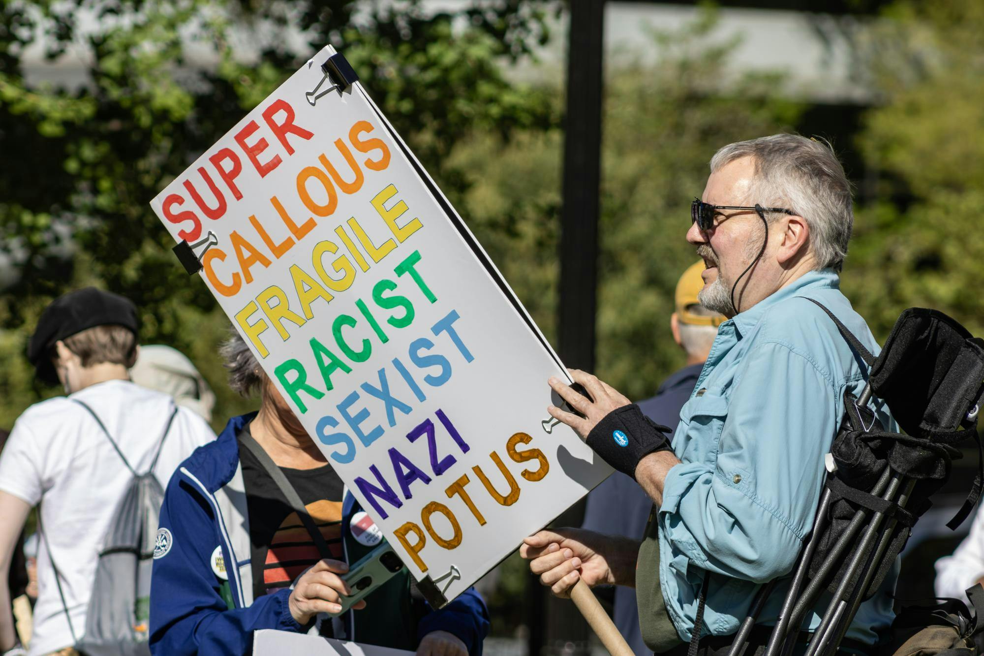 Matt Dronbik holds up his sign during the "No Kings" protest at the South Carolina State House on March 28, 2026. People attended the event carrying a wide variety of signs, ranging from humorous quips to powerful statements.