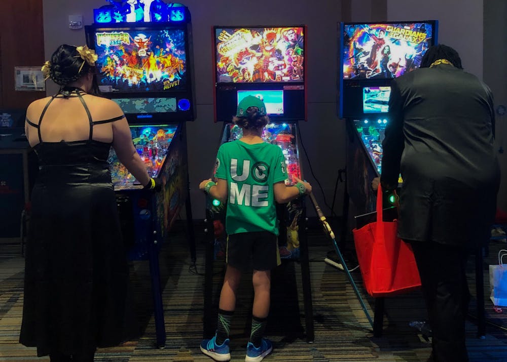 <p>Soda City Comic Con attendees play pinball games during the event hosted in the Columbia Metropolitan Convention Center on Saturday afternoon, August 20th 2022.</p>