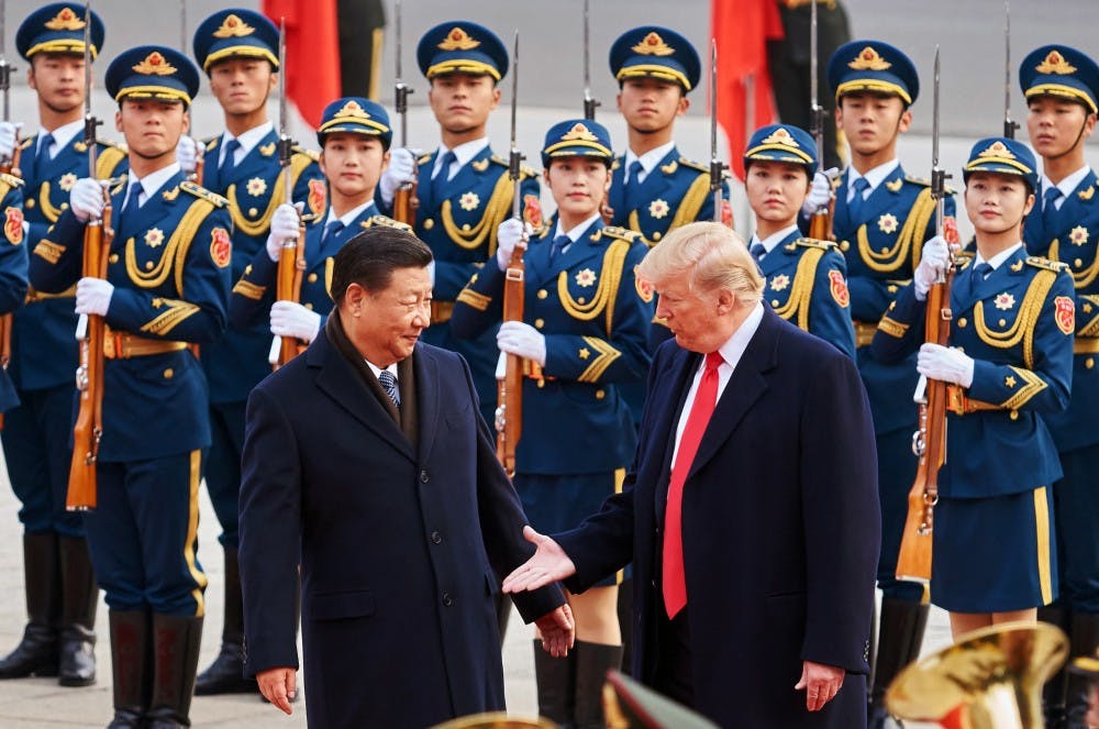 From left, China's President Xi Jinping and U.S. President Donald Trump shake hands on Thursday, Nov. 9, 2017 during a meeting outside the Great Hall of the People in Beijing, China. (Artyom Ivanov/Tass/Abaca Press/TNS)