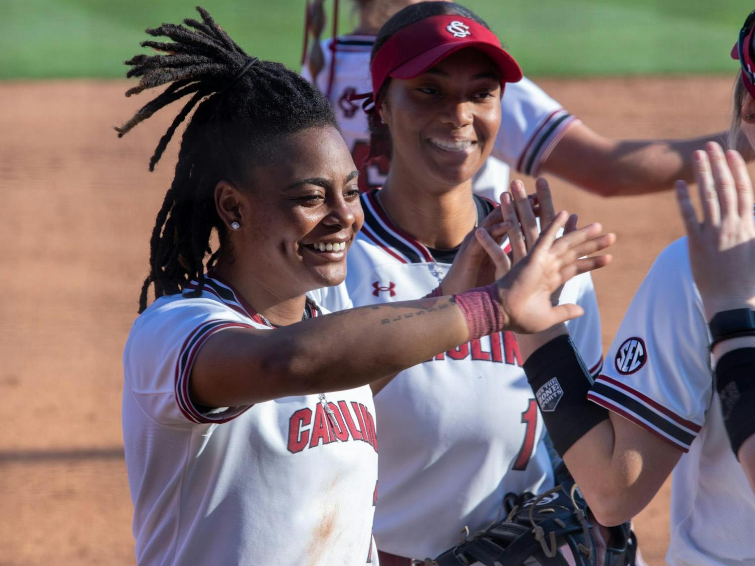 Bryant high-fives her teammates after making an out at third base in South Carolina's game against Boston University on March 14, 2024. The Gamecocks won against the Terriers after a walk-off home run.
