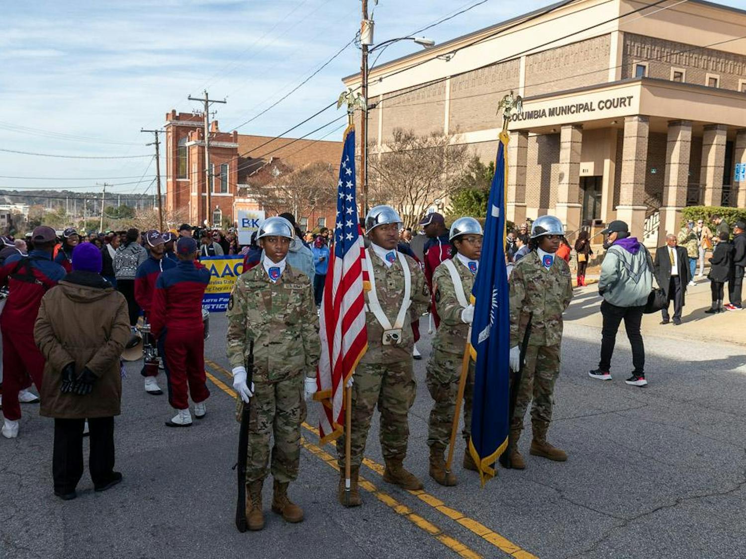 Members of the South Carolina State University ROTC color guard stand at parade rest as event organizers prepare to begin the march toward the South Carolina Statehouse on Jan. 15, 2024. The South Carolina NAACP, United Campus Workers organization and Alpha Kappa Alpha sorority were among the many local organizations that took part in the march.