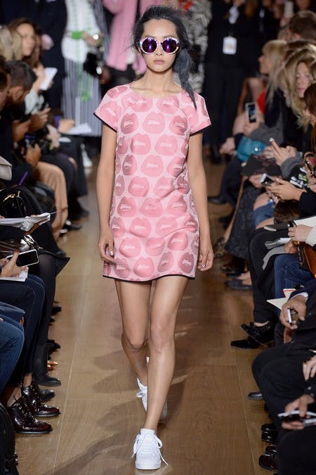 	The messy side braid compliments both the pop-art dress and sneaker combination shown at Giles.