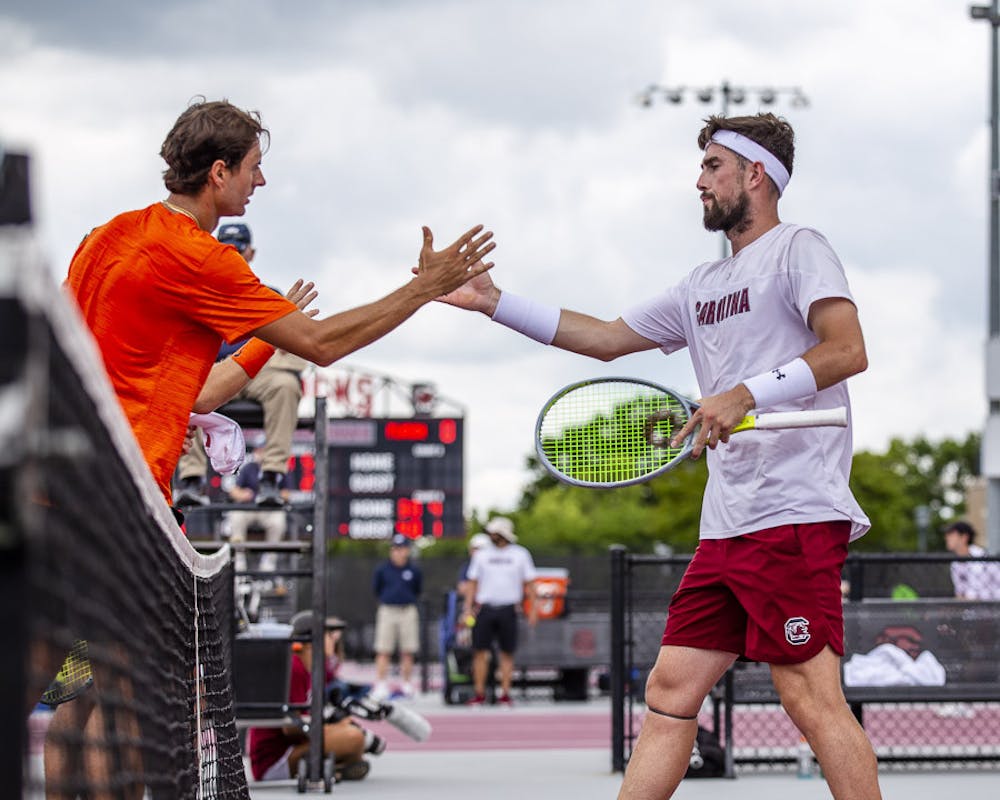 <p>Junior Connor Thomson (right) goes in to shake University of Florida graduate student Axel Nefve's hand (left) after Thomson and his teammate, junior Toby Samuel, lost their doubles match on April 16, 2023. &nbsp;The Gamecocks beat the Gators 5-2 overall.&nbsp;</p>