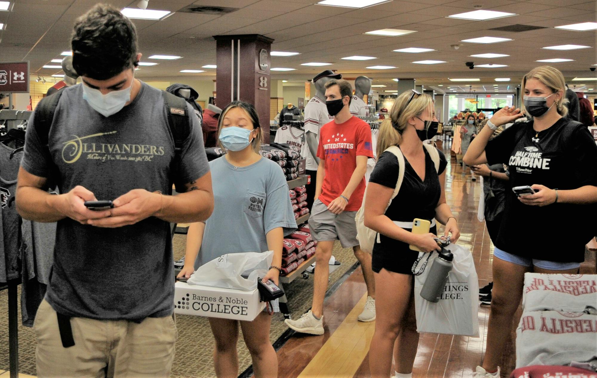 Students wear masks at the USC bookstore while waiting in line to pick up textbooks and course materials. On Feb. 21, 2022, USC announced they are only requiring masks in instructional, research and medical spaces on campus, as well as on-campus public transportation.