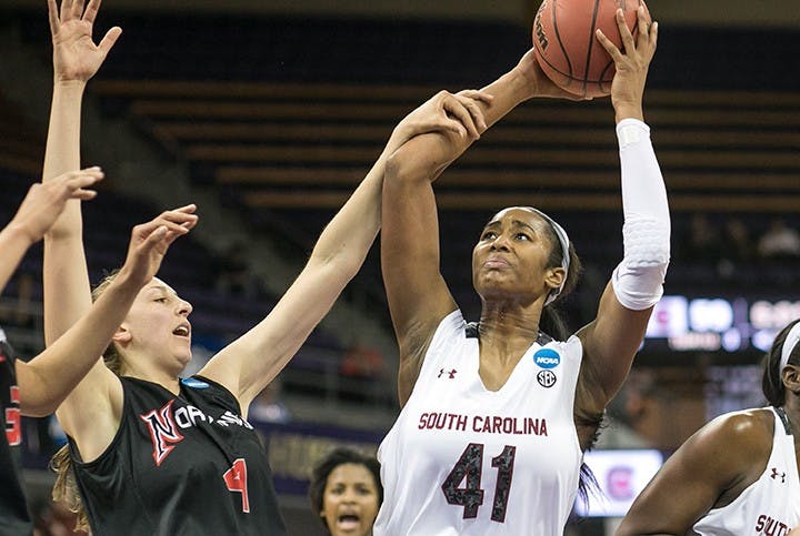 South Carolina&apos;s Alaina Coates (41) gets the rebound and attempts the put back in the second half, but gets fouled by CSU Northridge&apos;s Camille Mahlknecht during the first round of the women&apos;s NCAA Tournament in Seattle on Sunday, March 23, 2014. (Dean Rutz/Seattle Times/MCT)