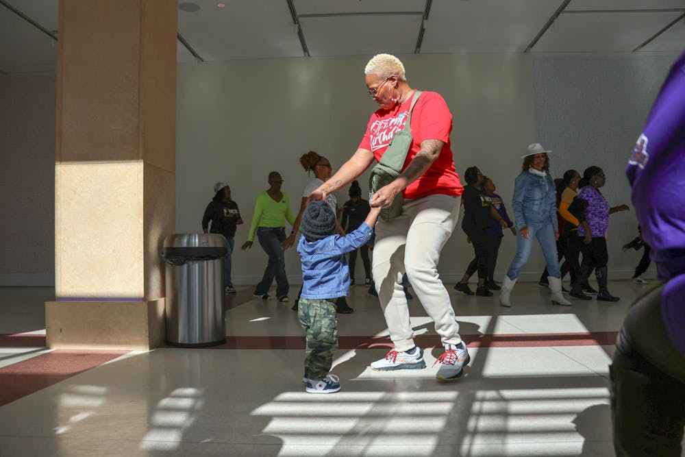 <p>A woman and a young child hold hands and dance at the Martin Luther King Jr. Day Line Dancing Event at the Boyd Plaza on Jan. 20, 2025. The Columbia Museum of Art hosted a special Martin Luther King Jr. Day program in honor of Martin Luther King Jr. Day featuring storytelling and line dancing.</p>