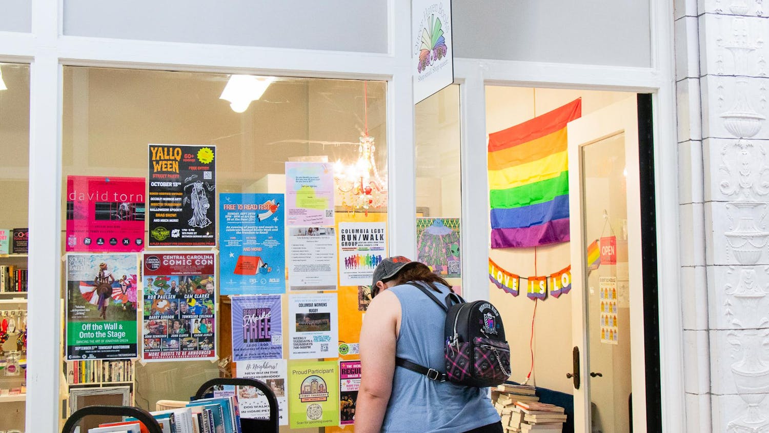 A customer looks at books and posters outside Queer Haven Books in Columbia, South Carolina, on Sept. 28, 2024. The store showcases items, including banned children's books and LGBTQIA+ themed zines.