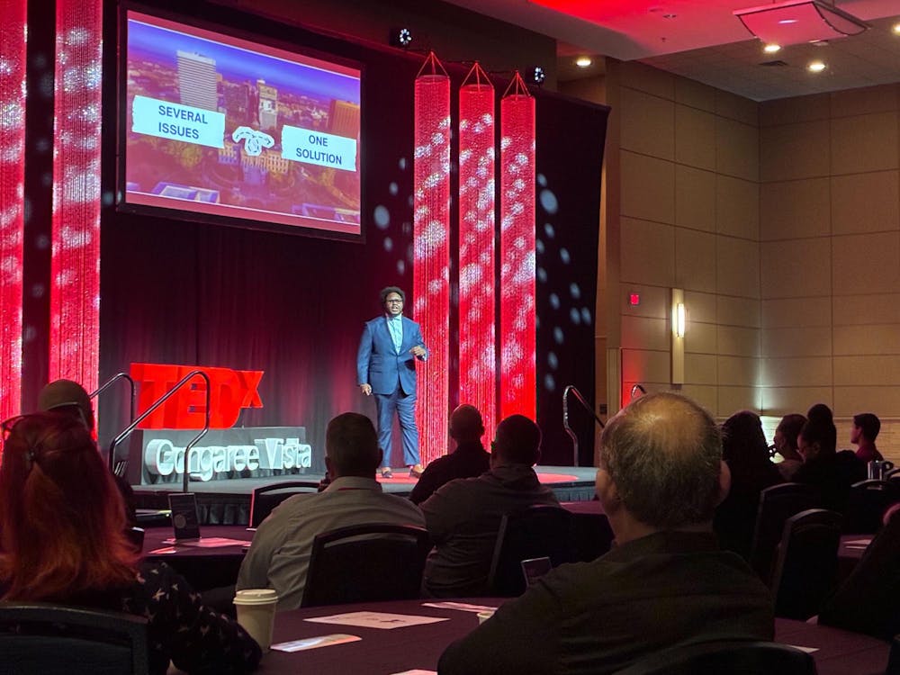 <p>Tyson Brown, executive director of Project OneWay, gives a speech about creating cities that encourage young talent to stay at the TEDxCongaree Vista event on March 14.</p>