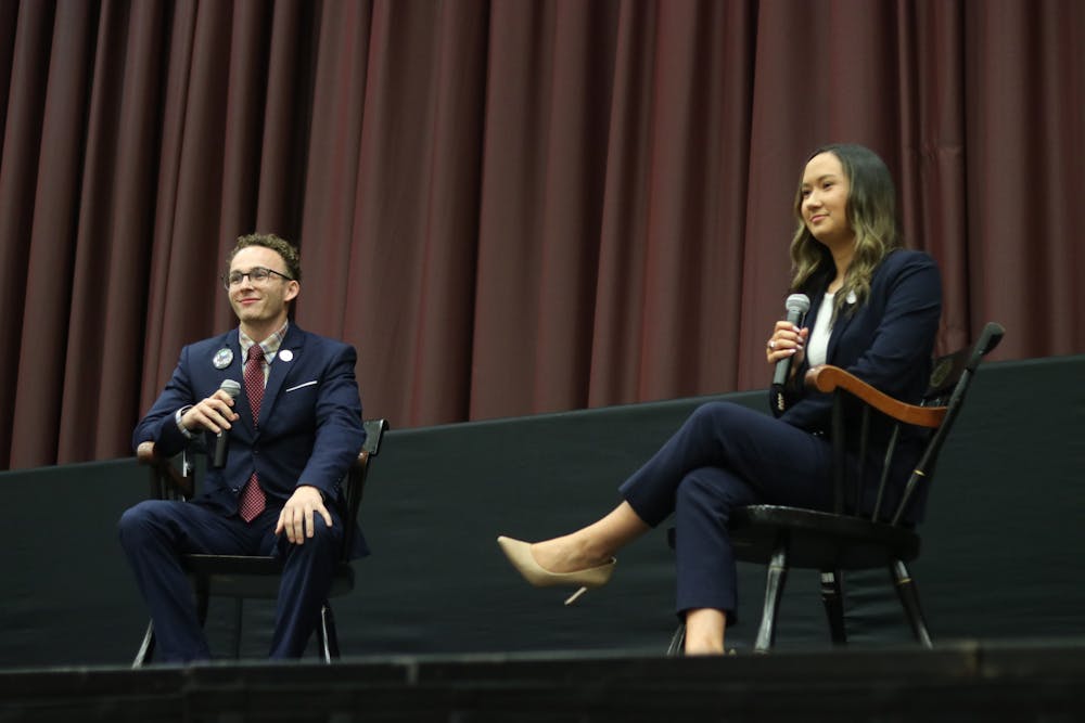 <p>Student body presidential candidates third-year political science student Reilly Arford (left) and third-year public relations student Emily "Emmie" Thompson (right) on stage debating on Feb. 15, 2023. They are the only two presidential candidates this election season.&nbsp;</p>