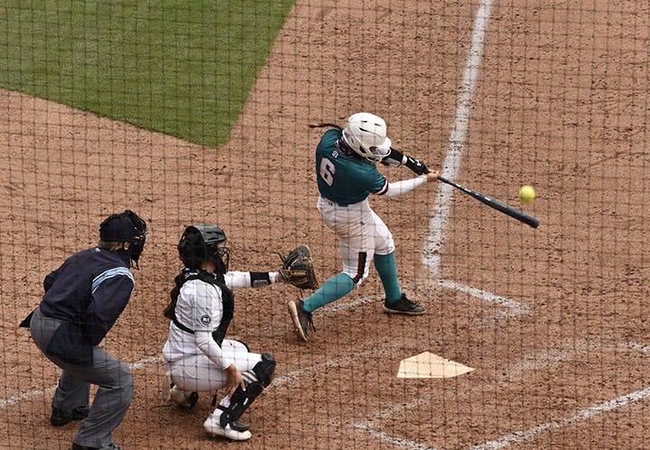 Junior catcher Jordan Fabian connects on a pitch in Sunday's game against the University of Central Florida. The Gamecocks wore teal for “All for Alex,” which is an organization that aids in the fight against ovarian cancer.&nbsp;