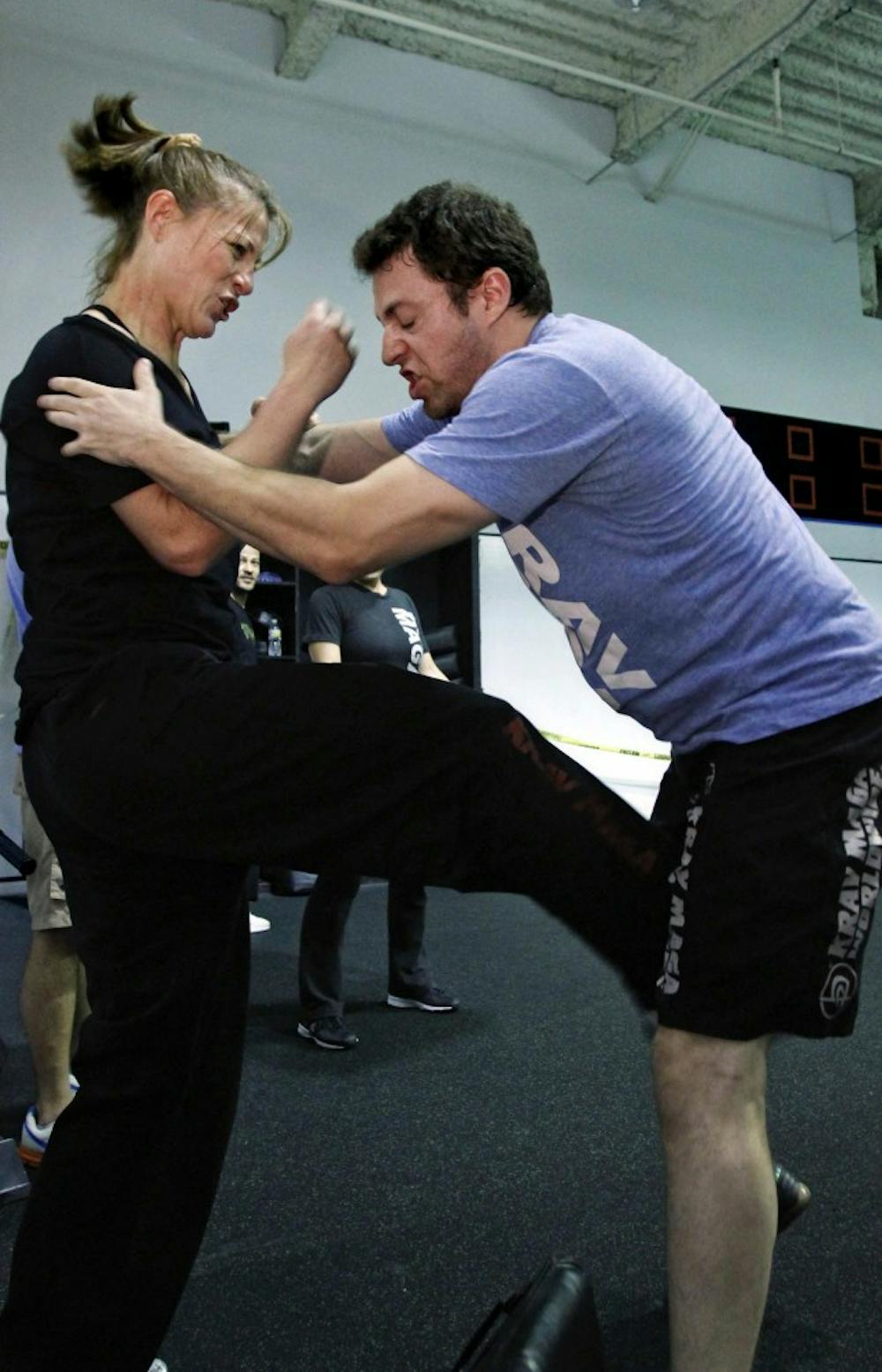 Lead instructor Kelly Campbell, left, demonstrates a groin kick against instructor Daniel Boluarte, in a Krav Maga self-defense class at KMW Training Center, December 15, 2010, in Santa Monica, California. (Ricardo DeAratanha/Los Angeles Times/MCT)