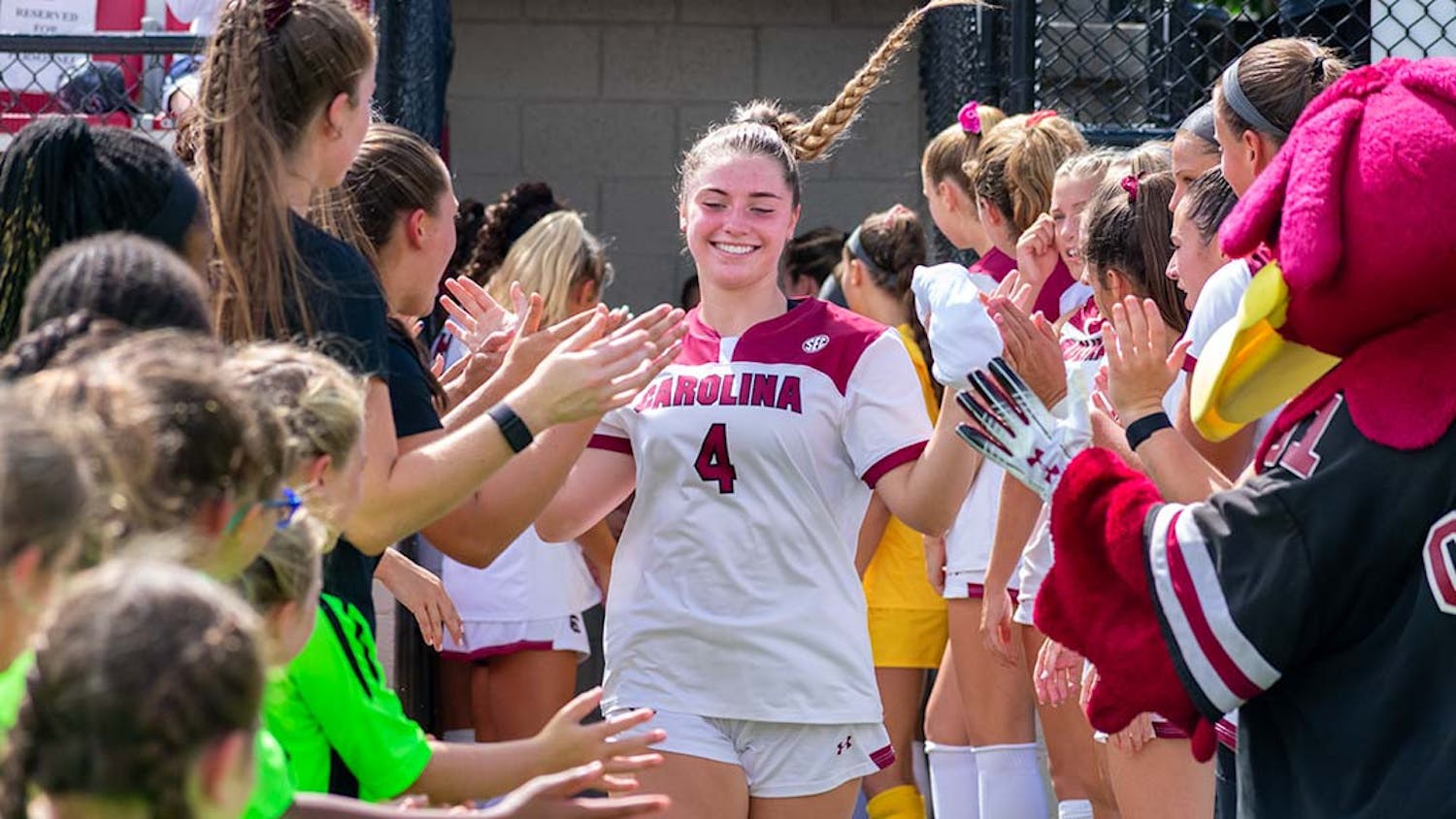 FILE — Freshman forward Sha O'Rourke high-fives her teammates as she makes her way to the field in preparation for their game against NC State on Sept. 11, 2022. The Gamecocks tied against the Wolfpack 0-0.