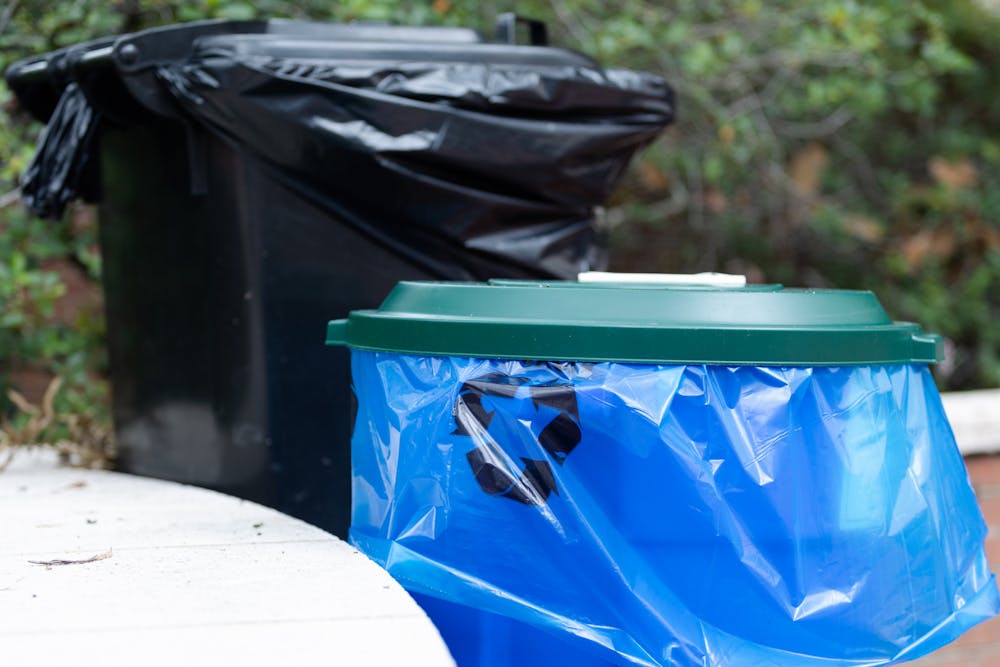 A picture of a recycling bin and trash can outside of Russell House on Aug. 29, 2022. Bags for recyclable materials are blue so that the items can be kept separate from waste going to the landfill. 
