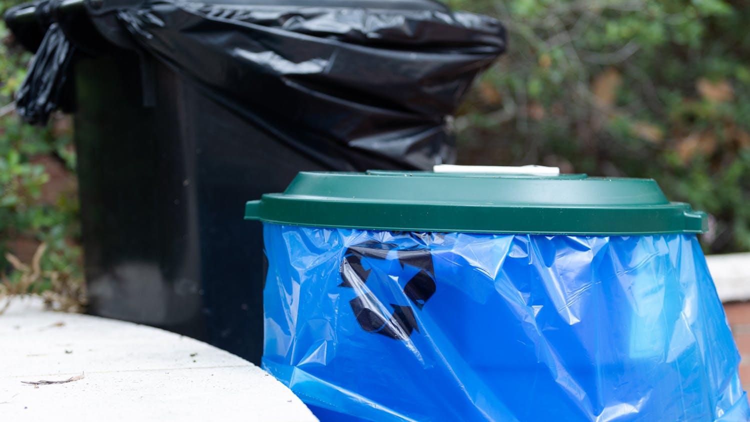 A picture of a recycling bin and trash can outside of Russell House on Aug. 29, 2022. Bags for recyclable materials are blue so that the items can be kept separate from waste going to the landfill. 