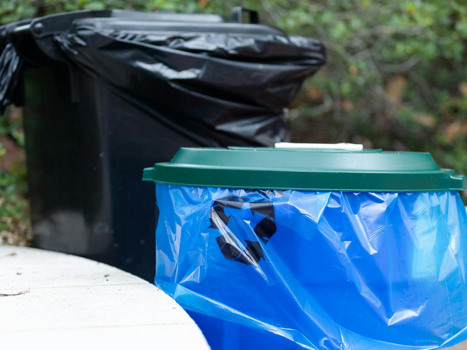 A picture of a recycling bin and trash can outside of Russell House on Aug. 29, 2022. Bags for recyclable materials are blue so that the items can be kept separate from waste going to the landfill.