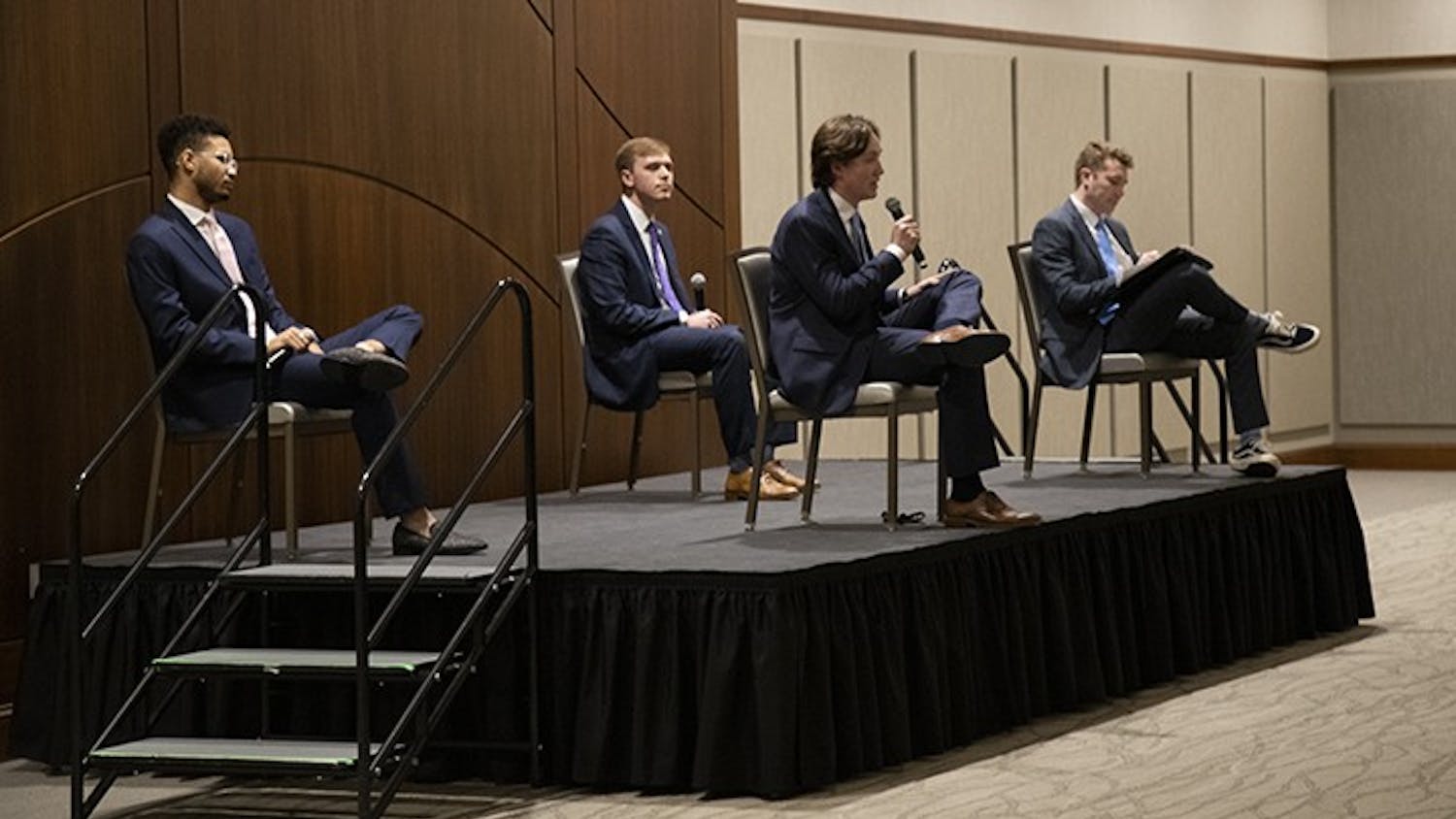 Student body president candidates (from left to right) Aidan Baker, Alex Harrell and Cameron Butler listen to Caden Askew's answer to a question. The candidates were asked a series of general questions, individual questions and questions pulled from social media.