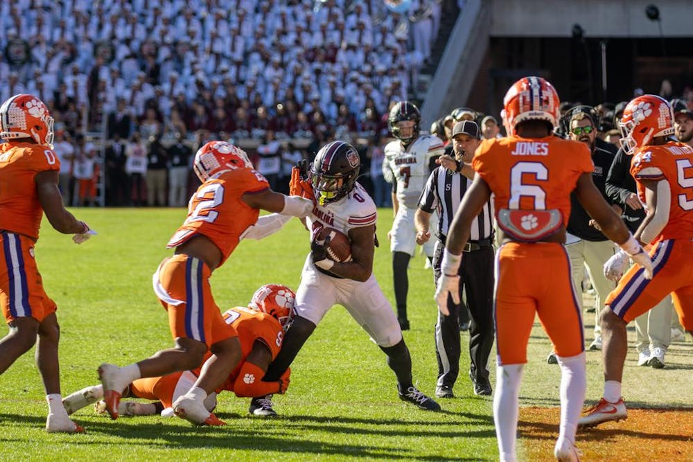 <p>FILE — Junior tight end Jaheim Bell is pushed out of bounds by a member of Clemson's defense on Nov. 26, 2022, at Memorial Stadium. South Carolina will be facing off against Clemson on Saturday at 7:30 p.m. in Williams-Brice Stadium.</p>