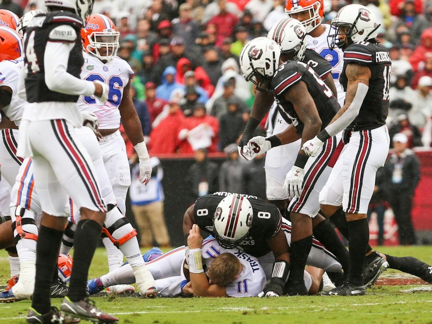 Senior defensive lineman D.J. Wonnum takes down a Florida player with the ball during the game.