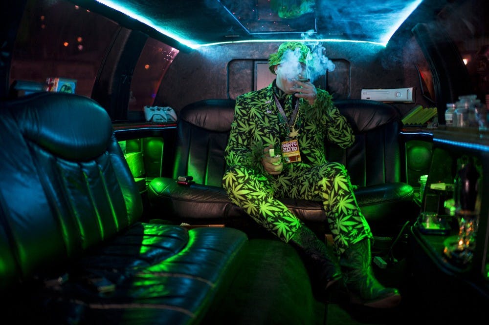 Mike Barnes takes a celebratory puff in his privately owned "420 Limo" at an election party in Oakland, Calif., after the passage of proposition 64, which legalized and taxed the recreational use of marijuana in California, in November 2016. (Andrew Seng/Sacramento Bee/Zuma Press/TNS)