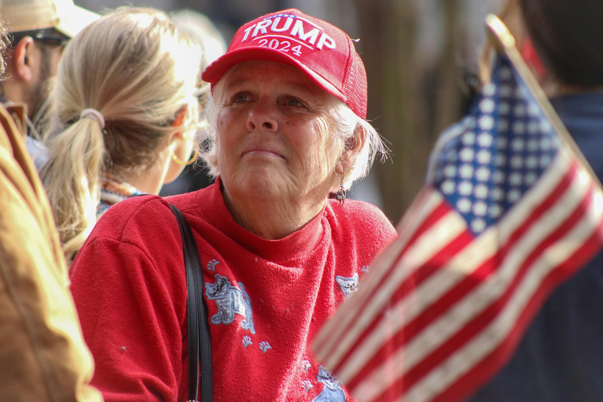 People young and old waited on the Statehouse lawn on Jan. 28, 2023. Decked in American flags and MAGA hats, supporters turned out on both sides of the Statehouse fence for former President Donald Trump's Columbia visit.&nbsp;