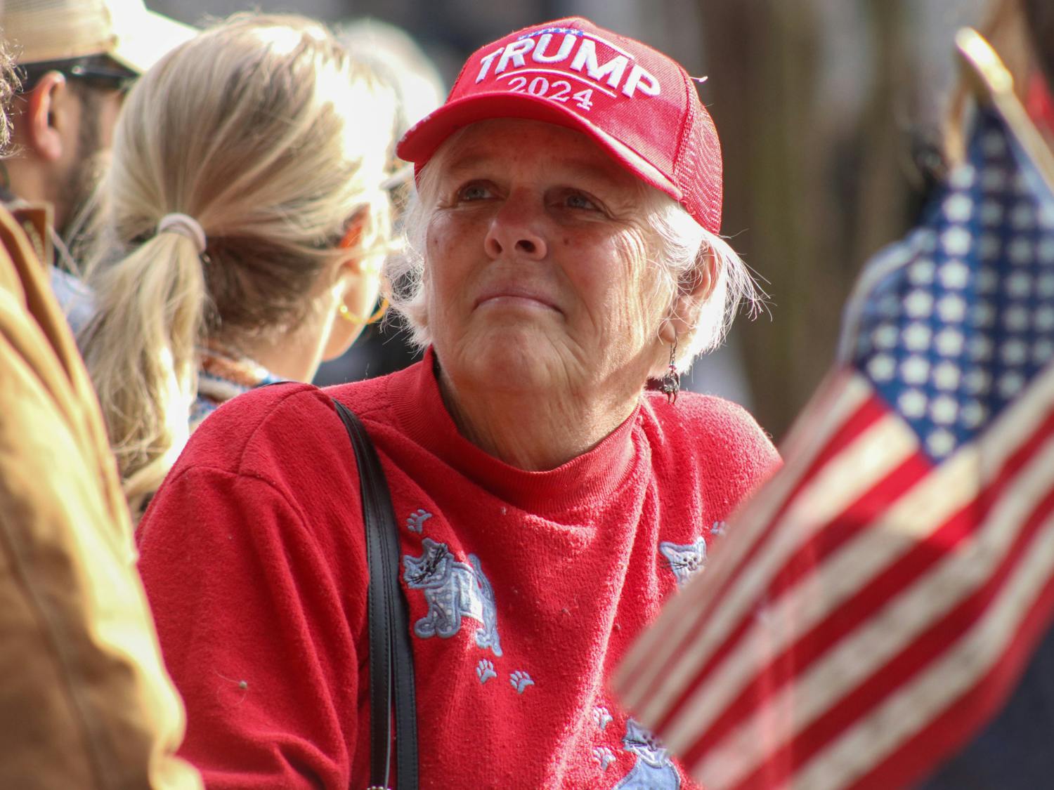 People young and old waited on the Statehouse lawn on Jan. 28, 2023. Decked in American flags and MAGA hats, supporters turned out on both sides of the Statehouse fence for former President Donald Trump's Columbia visit.&nbsp;