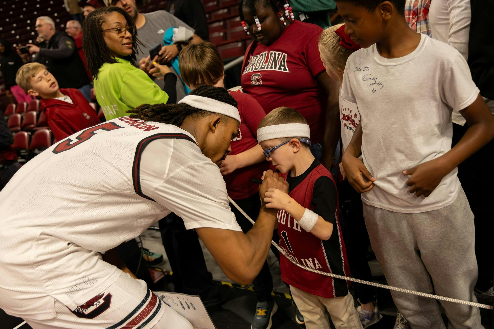 Redshirt senior guard Meechie Johnson signs the jersey of a young Gamecocks fan after the game against Charleston Southern on Nov. 28, 2025. Johnson previously played for Ohio State before transferring to USC.