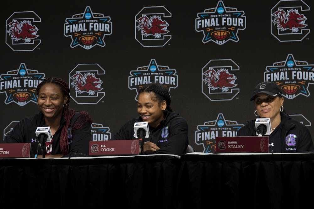 <p>FILE — Senior guard Zia Cooke, senior forward Aliyah Boston and head coach Dawn Staley share smiles after Cooke explains how Staley reminds them to stay calm while under pressure at the Women’s Final Four media availability meeting on Mar. 30, 2023, in Dallas, Texas. Staley reminds her team to not get too attached in the moment and “not get too high with the highs and low with the lows.”&nbsp;</p>