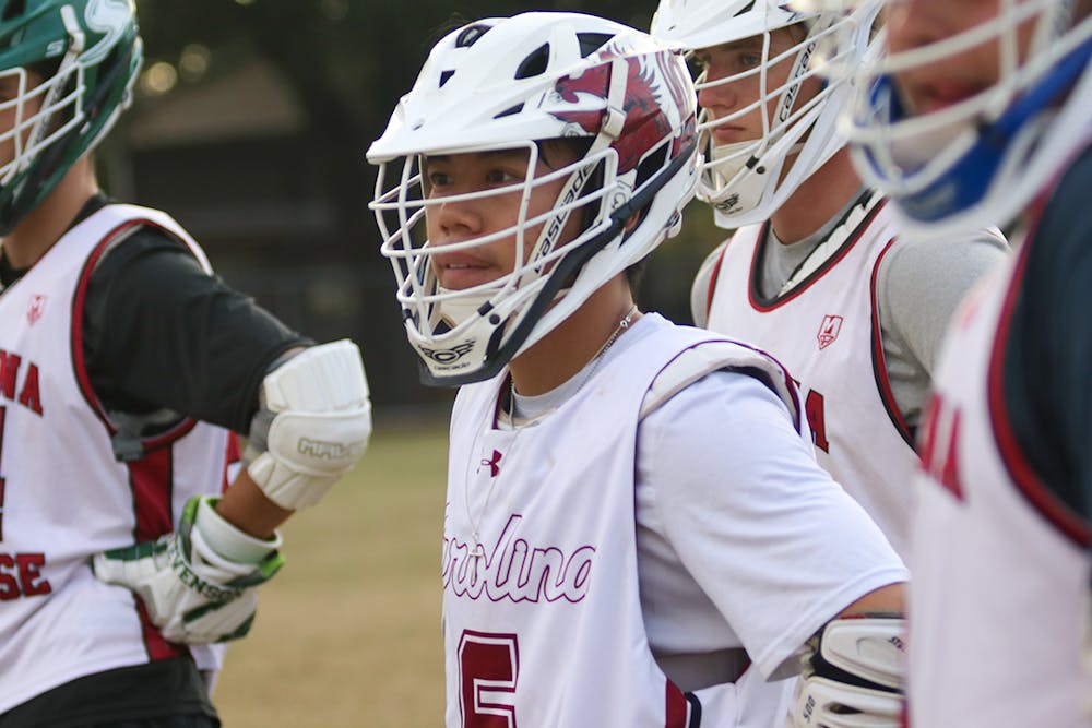<p>South Carolina men's lacrosse club president and fourth-year computer science student Kevin Nguyen catches a breath before jumping right back into scrimmages during practice on Oct. 5, 2022. Nguyen joined the team in 2019 as a freshman and is ready to play his senior year as president.</p>