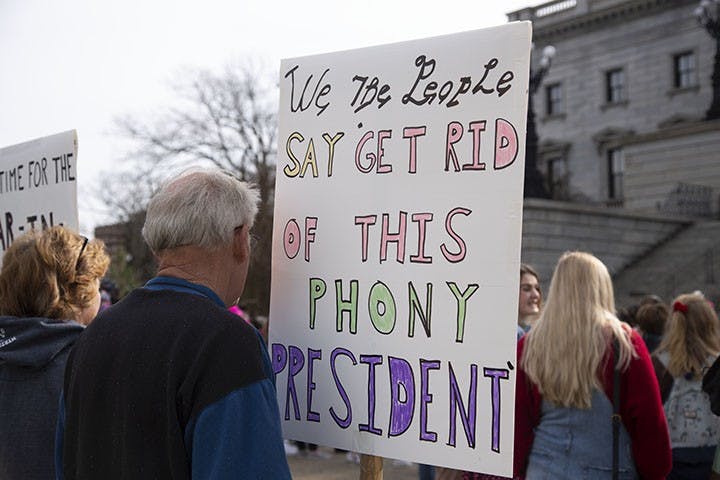 Bruce Sorenson, Retired
The couple from East Over, South Carolina, attended the Women’s March holding signs that showed their opinions on President Trump. Mrs. and Mr. Sorenson believe President Trump is a liar and a phony, as stated on their signs.